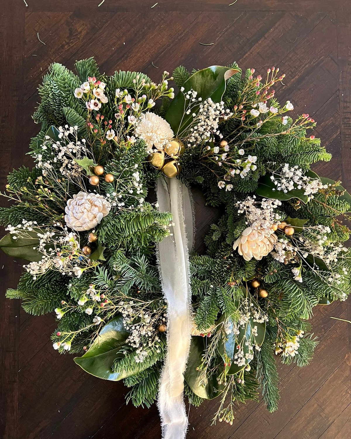 A hand-made Gatherwell wreath in cream and gold